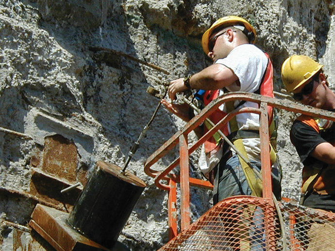 man grouting around anchor of trade center foundation