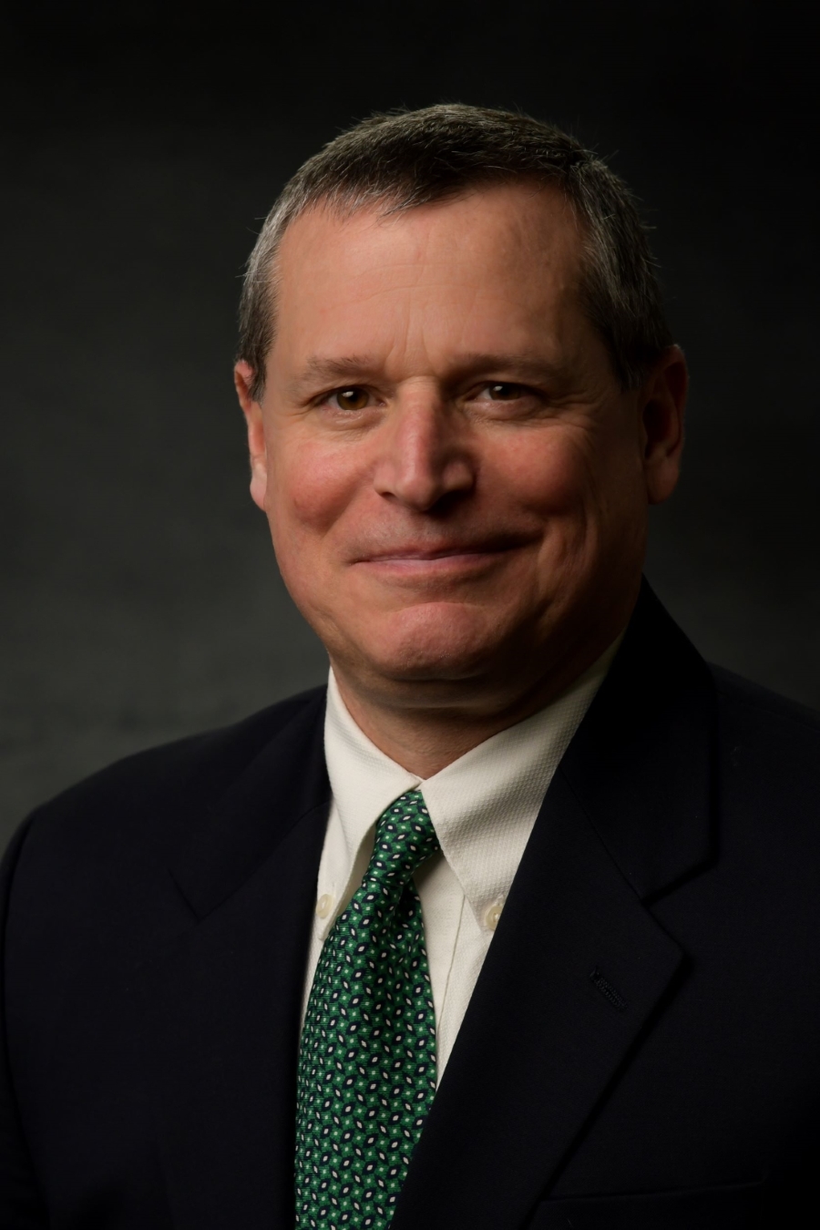 man in black suit with green tie
