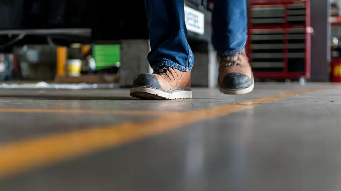 Man in safety boots walking a line