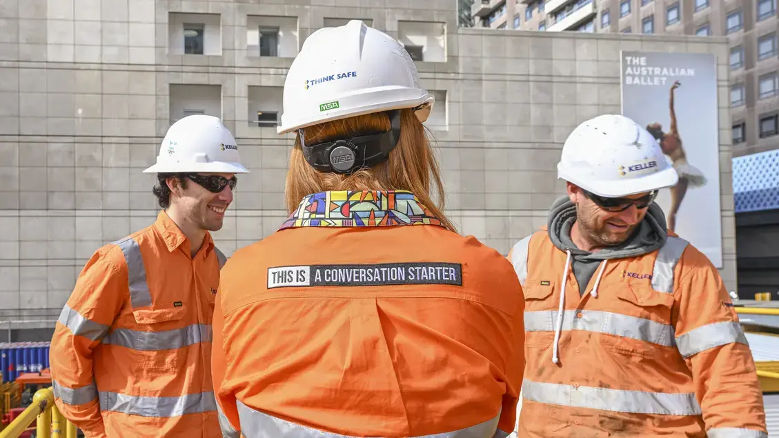 Female worker with a "this is a conversation starter" shirt on