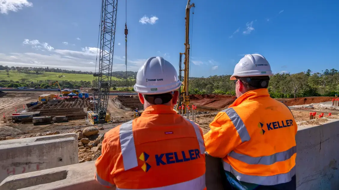 2 employees overlooking job site