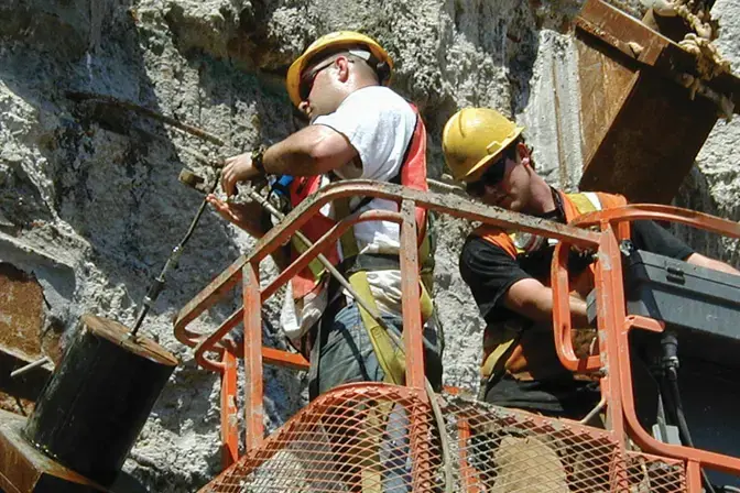 man grouting around anchor of trade center foundation