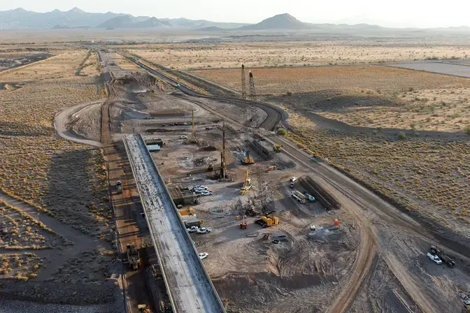 aerial view of half constructed bridge in the desert