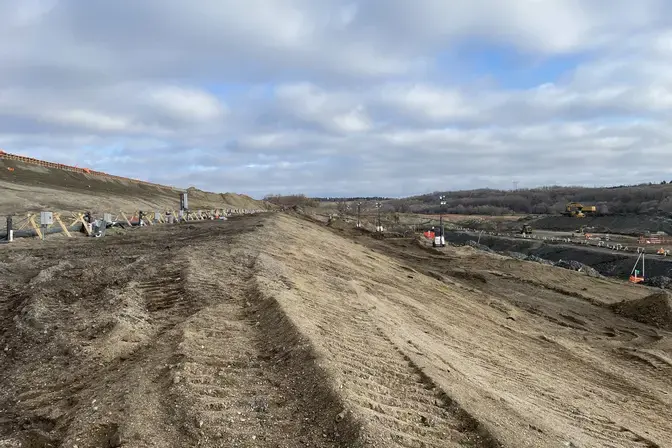 a dirt hill with dewatering pipes