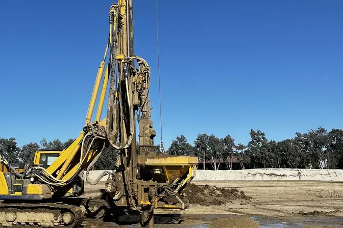 drill rig on a muddy jobsite