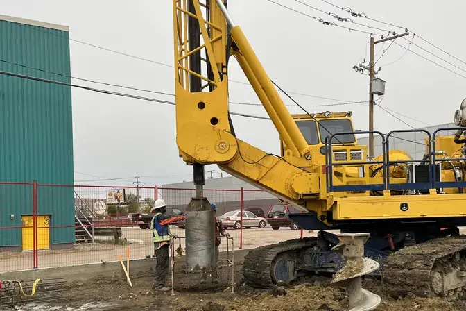 drilling on job site with yellow rig