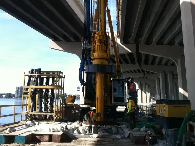 Installing drilled shafts between two bridges