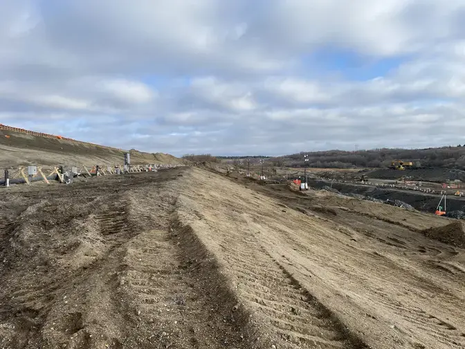 a dirt hill with dewatering pipes