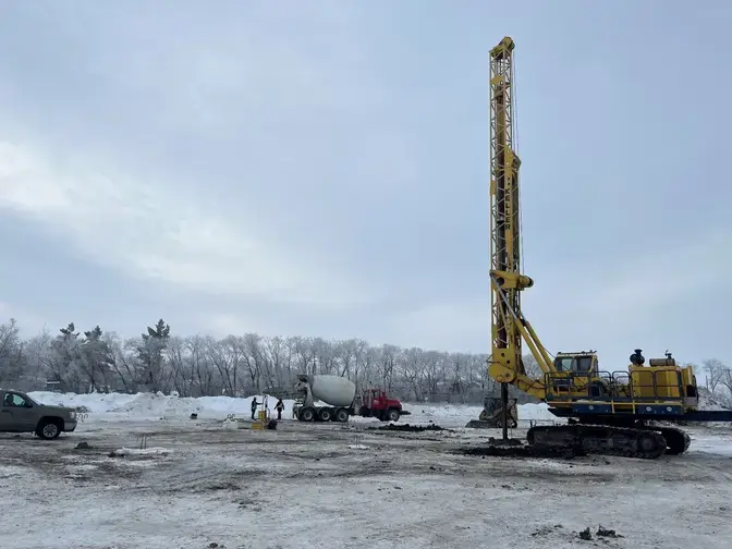construction site with concrete truck and drilled shaft rig