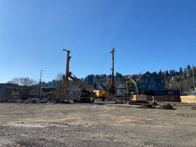 several rigs on a construction site with a blue sky