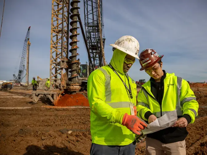 Two employees discussing a site plan