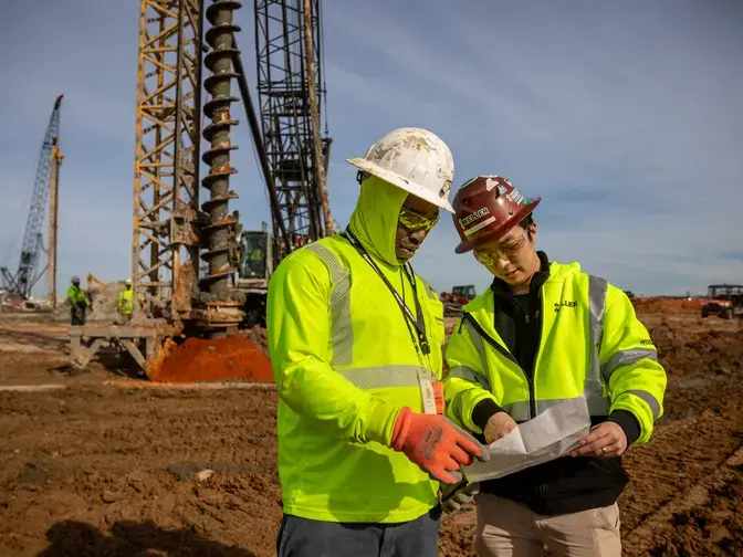 Two Keller employees discussing a site plan
