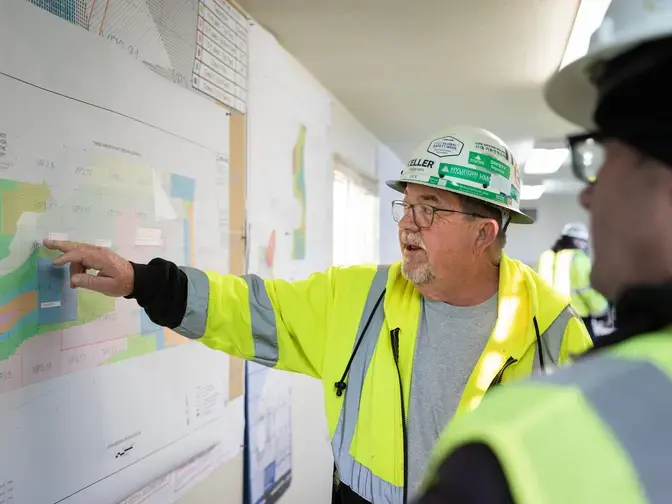 Keller employee pointing to a site plan