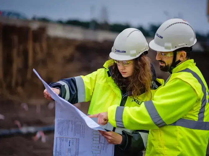 Two employees discussing a site plan