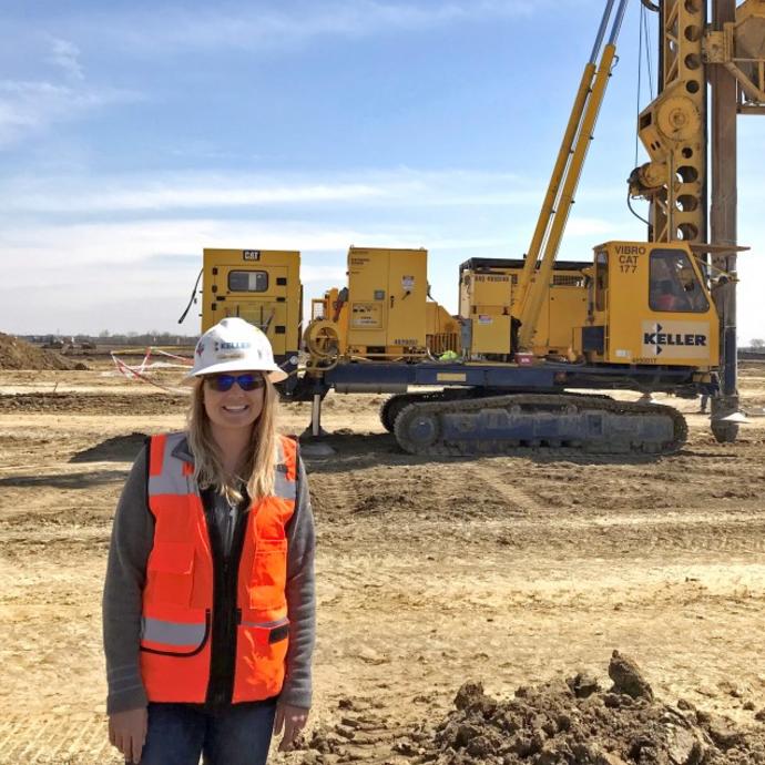 Women posing in front of rig