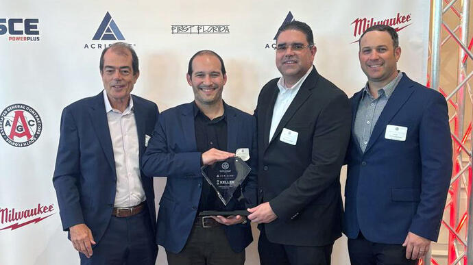 4 men holding award