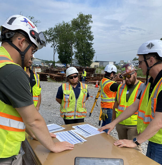 Keller employees discussing a manual