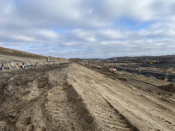 a dirt hill with dewatering pipes