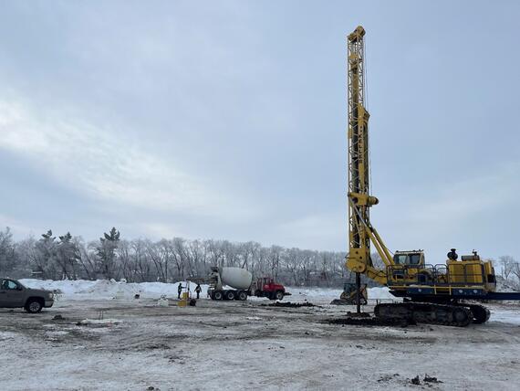 construction site with concrete truck and drilled shaft rig