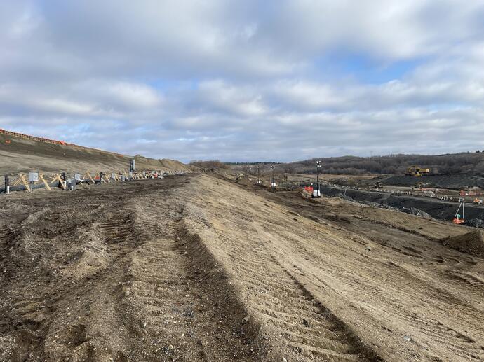 a dirt hill with dewatering pipes