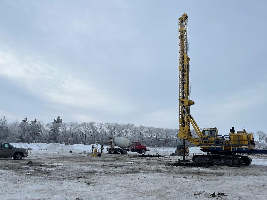 construction site with concrete truck and drilled shaft rig