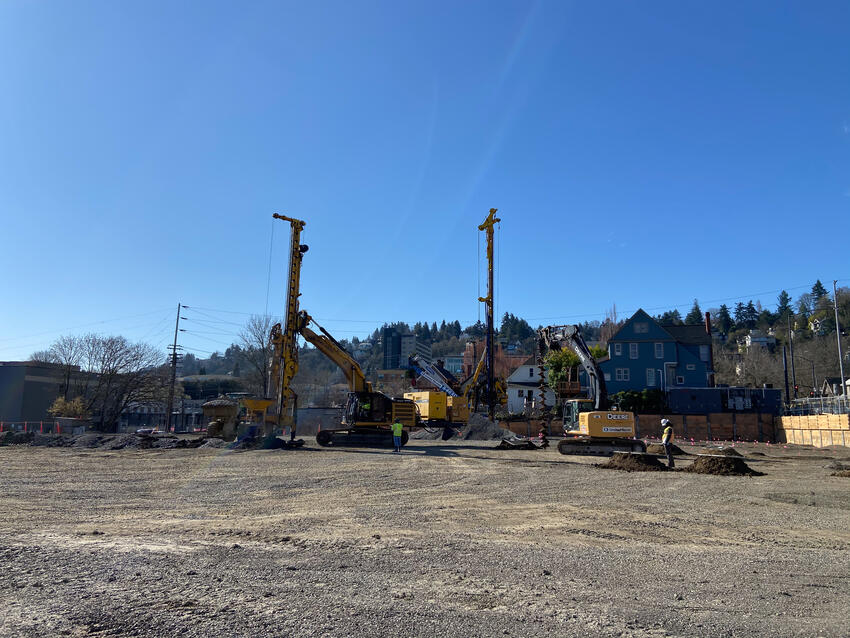 several rigs on a construction site with a blue sky