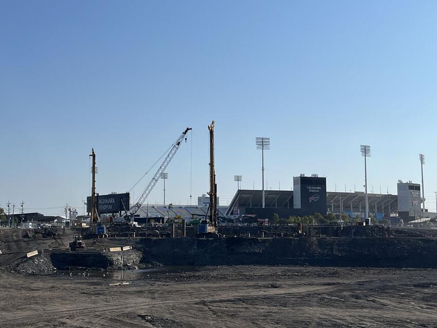 construction site in front with distant football stadium in the background