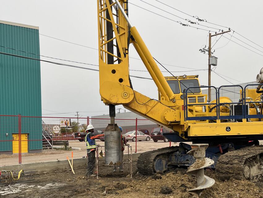 drilling on job site with yellow rig